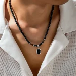 collier de perles noires avec pendentif carré